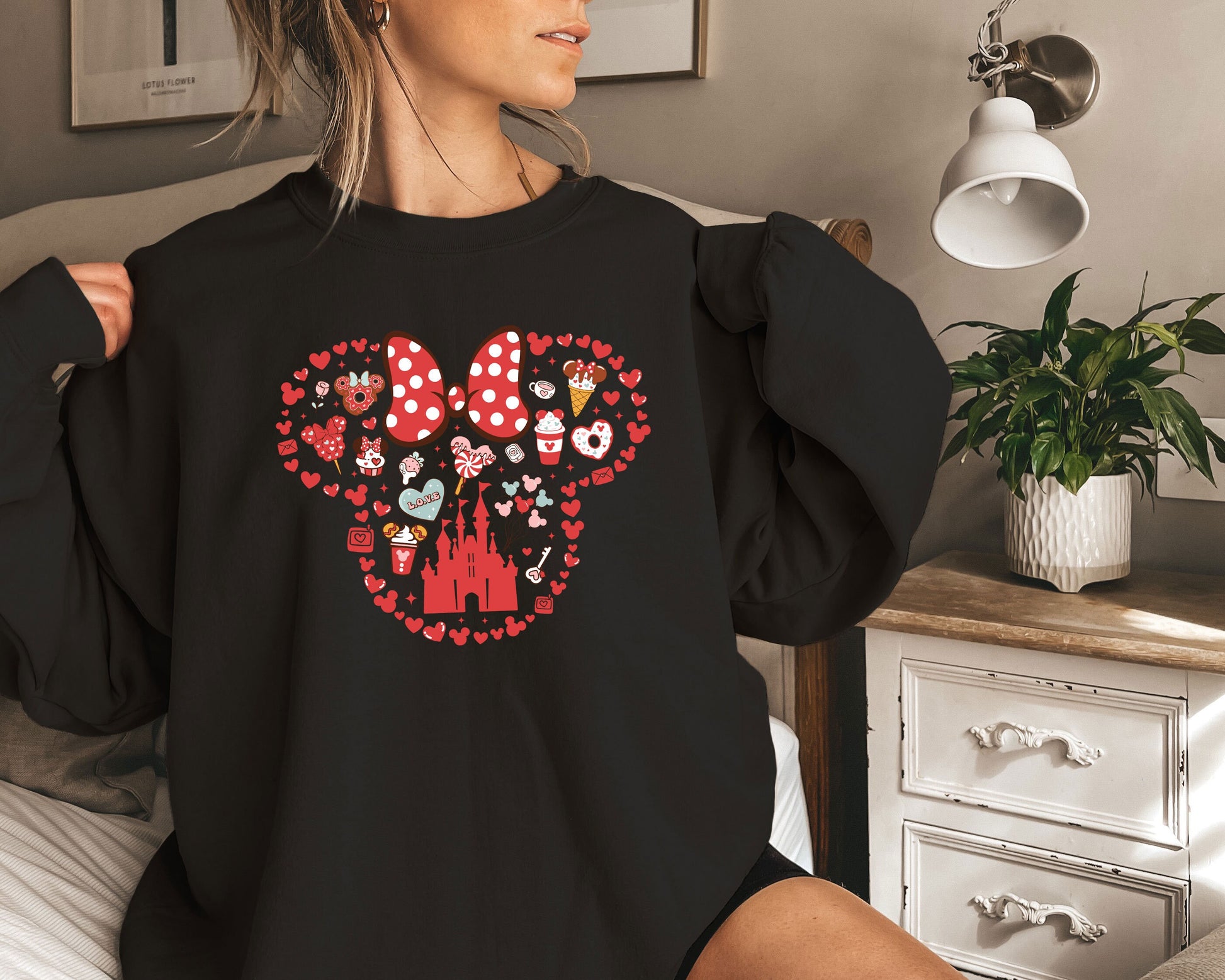 a woman wearing a black shirt with minnie mouse on it