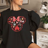 a woman wearing a black shirt with minnie mouse on it