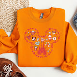a pair of shoes and a sweatshirt with mickey mouse on it