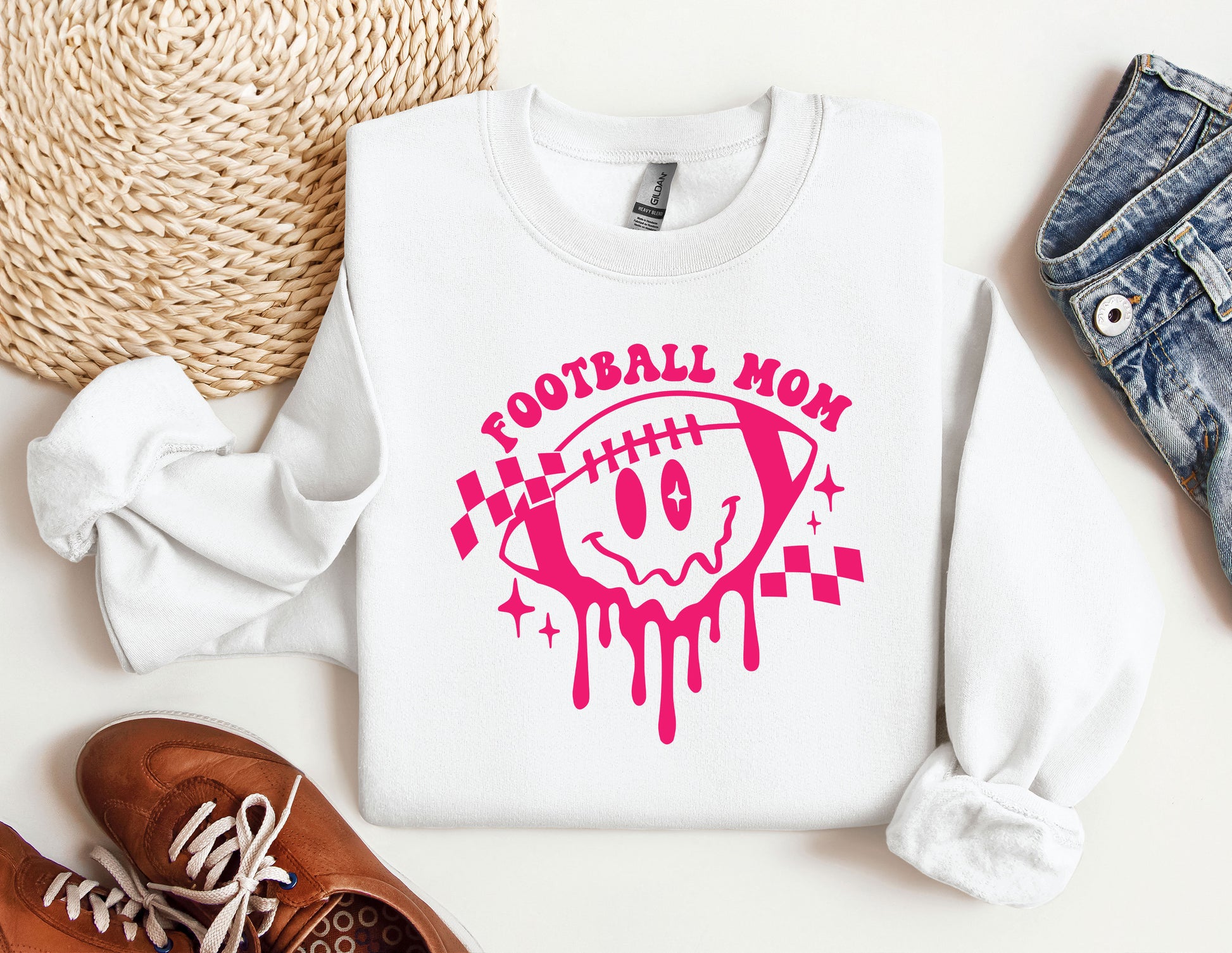 a white shirt with a pink football mom on it