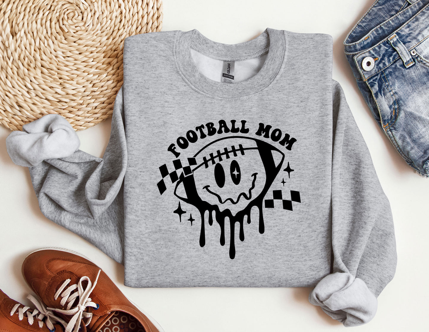 a sweatshirt that says football mom with a skull on it