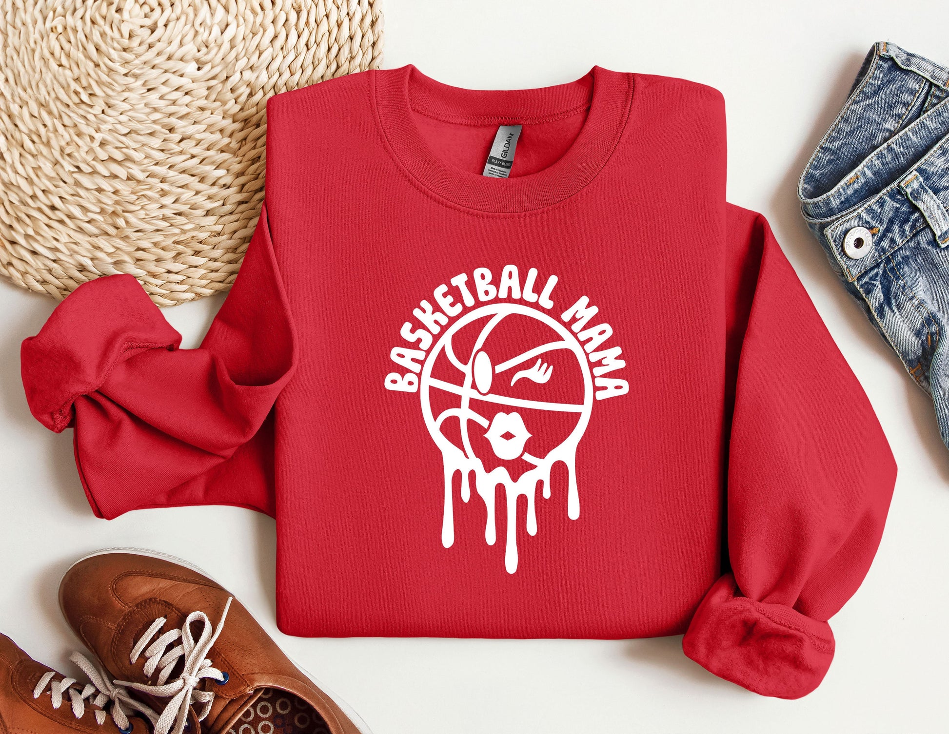 a red sweatshirt with a basketball drawn on it