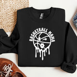 a black sweatshirt with white paint dripping down it