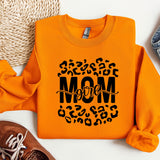 an orange sweatshirt with the word mom printed on it
