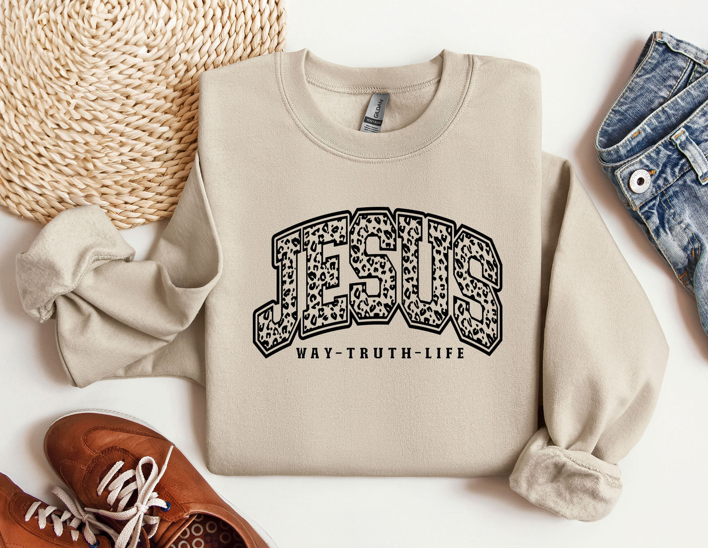 a sweater with the word jesus on it next to a pair of shoes