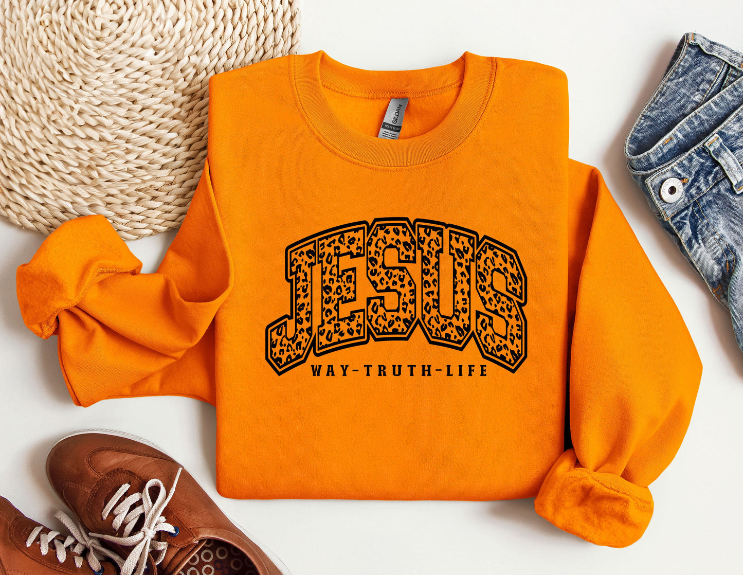 a pair of shoes and a sweatshirt with the word jesus on it