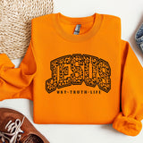 a pair of shoes and a sweatshirt with the word jesus on it