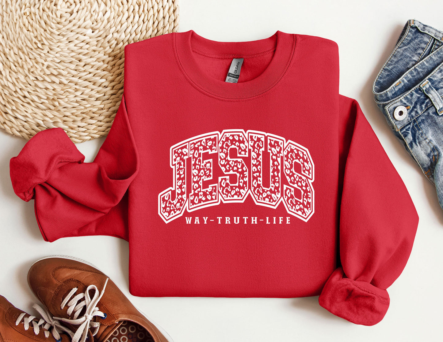 a red sweatshirt with the word jesus on it