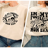 a woman wearing a sweatshirt that says in my football mom era