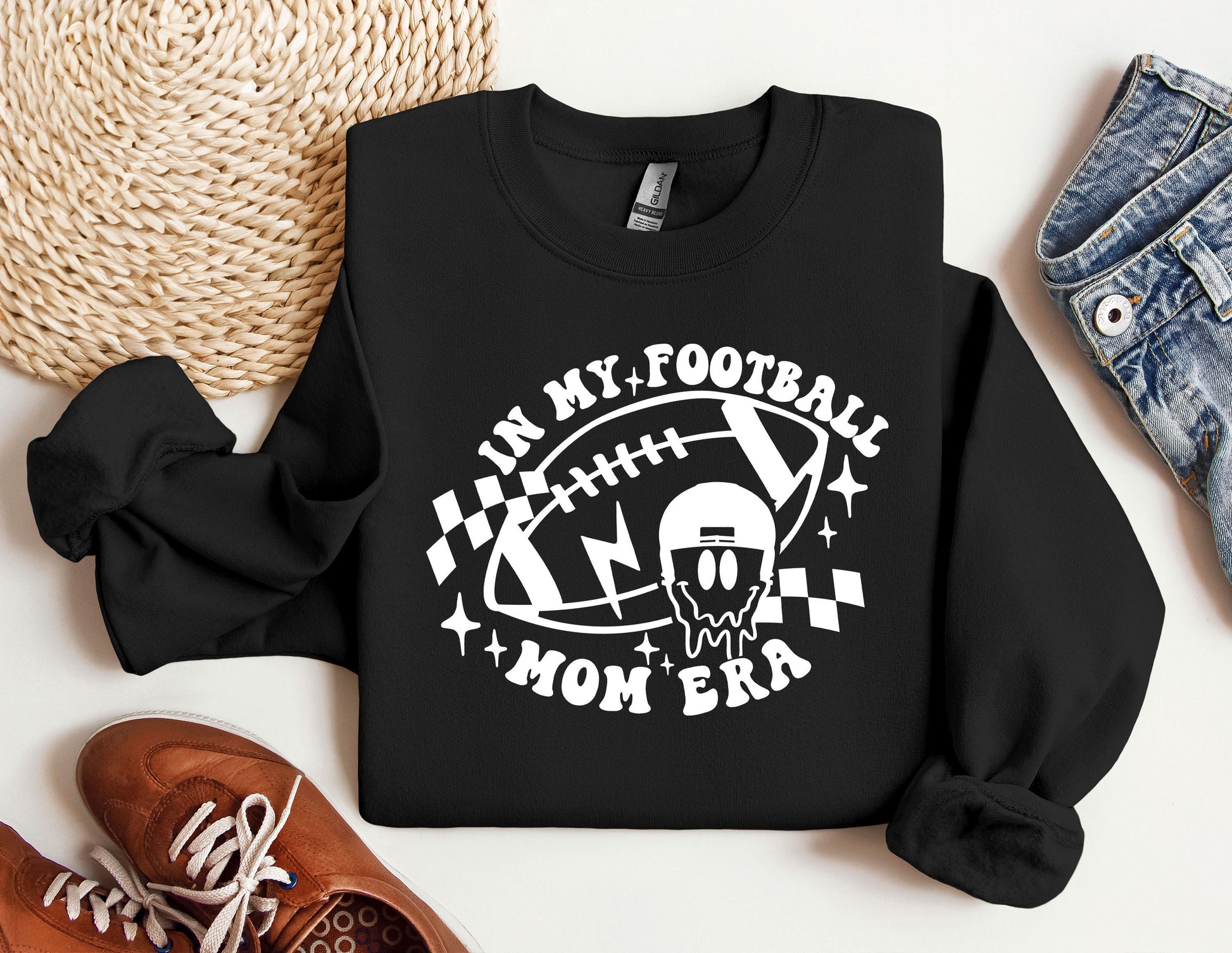 a black sweatshirt with a football design on it