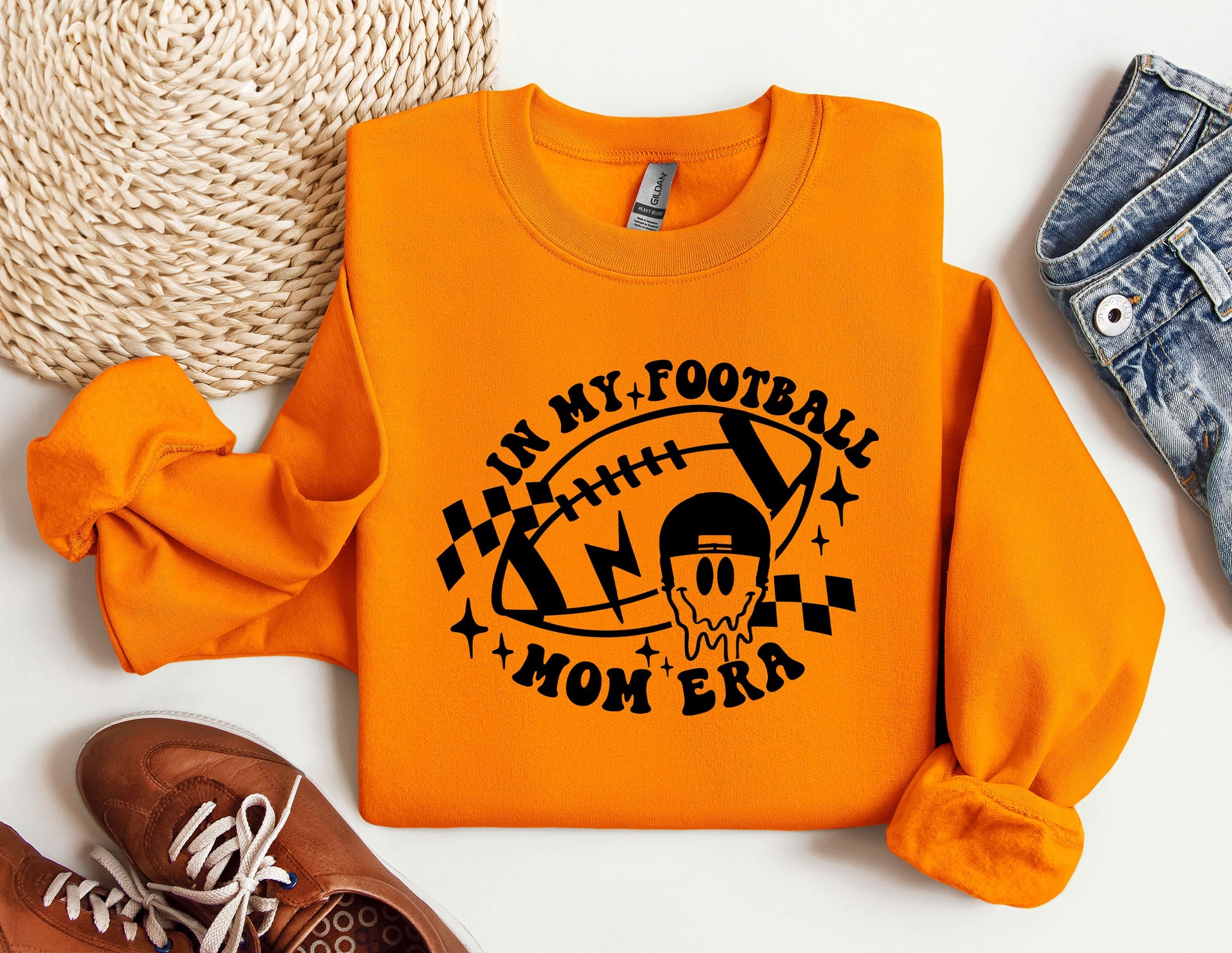 an orange shirt with a football mom on it