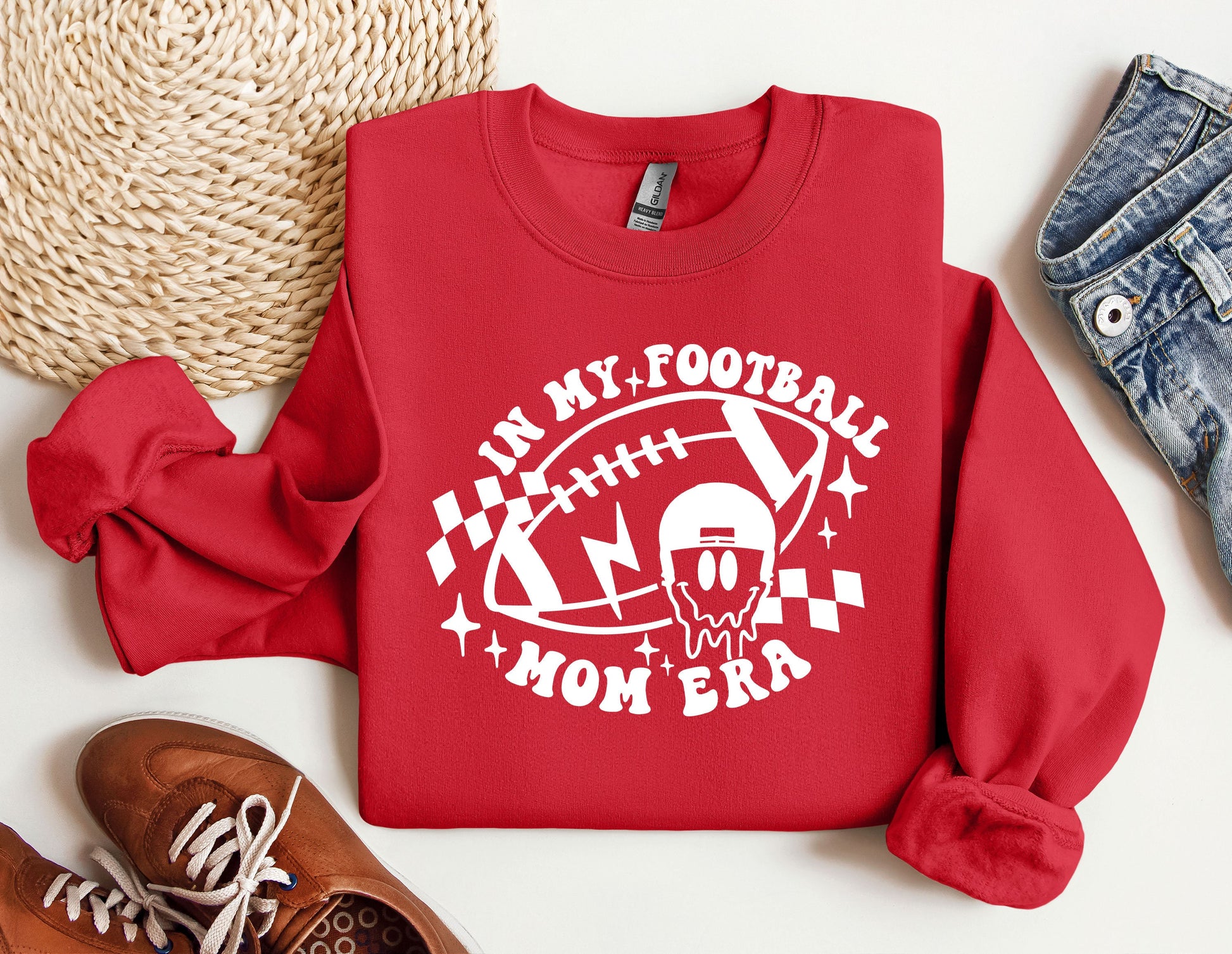 a red sweatshirt with a football mom on it