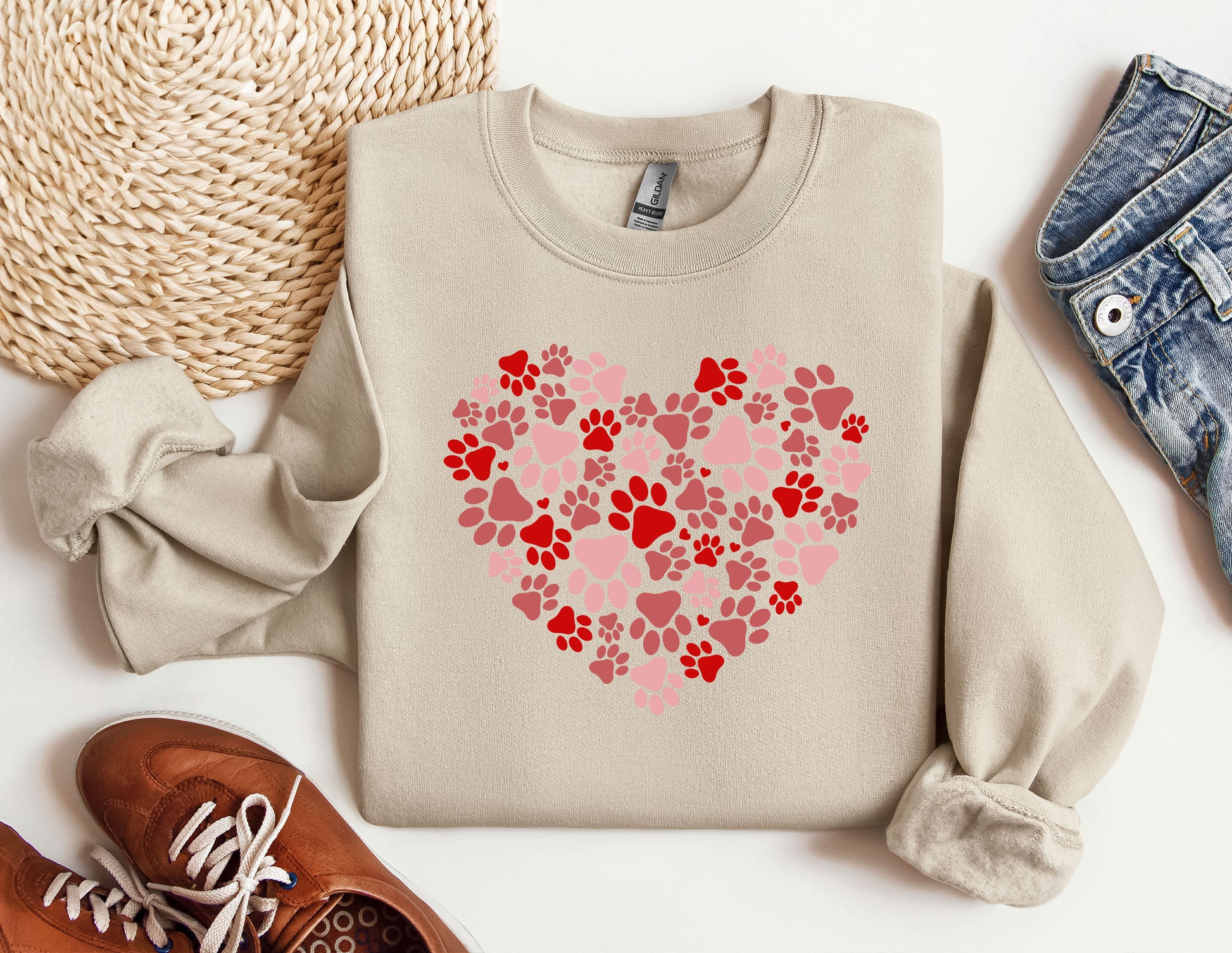 a sweater with a heart made out of paw prints