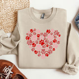 a sweater with a heart made out of paw prints