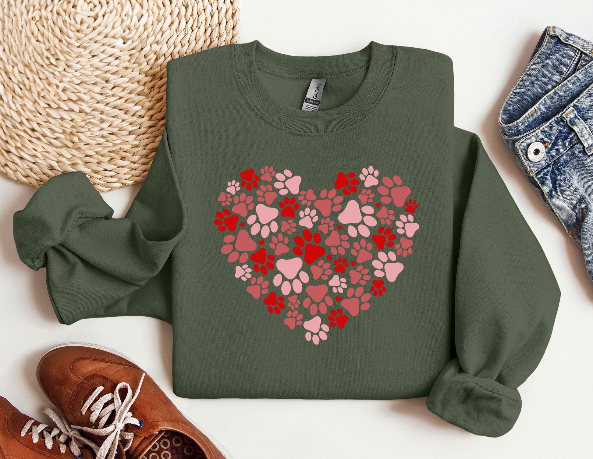 a green sweatshirt with a heart made of paw prints