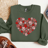 a green sweatshirt with a heart made of paw prints