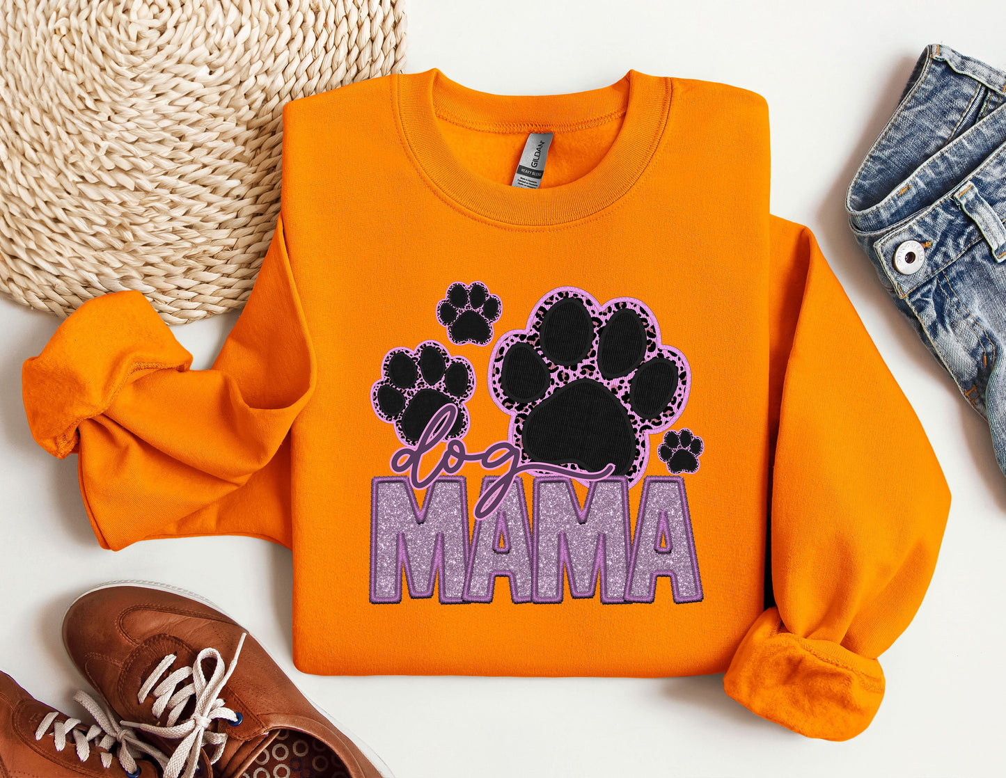 a pair of shoes and an orange sweatshirt with the word mama printed on it