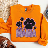 a pair of shoes and an orange sweatshirt with the word mama printed on it