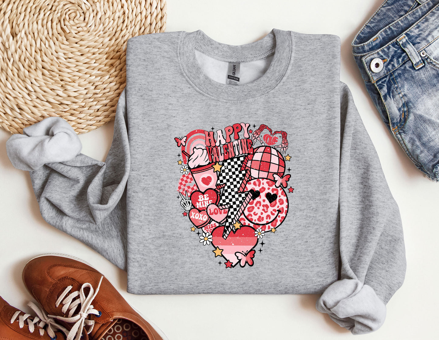 a sweater with a heart on it next to a pair of shoes