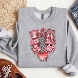 a sweater with a heart on it next to a pair of shoes