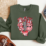 a green sweatshirt with a heart on it next to a pair of shoes