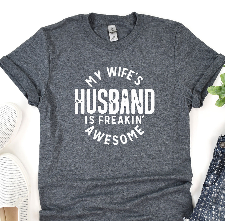 a t - shirt that says, my wife's husband is freakin '