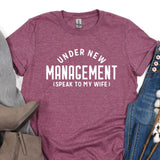 a t - shirt that says under new management speak to my wife