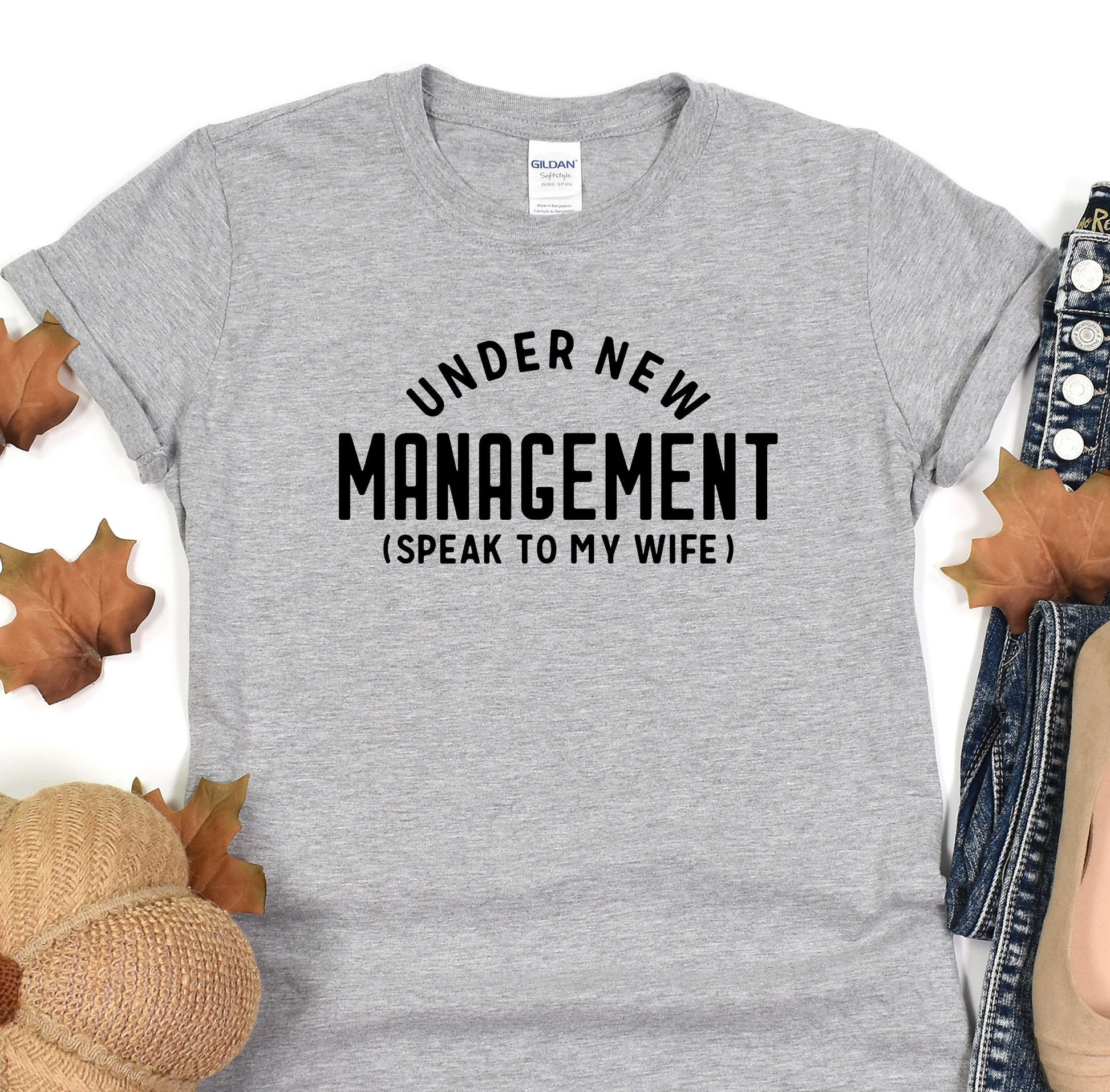 a t - shirt that says under new management speak to my wife