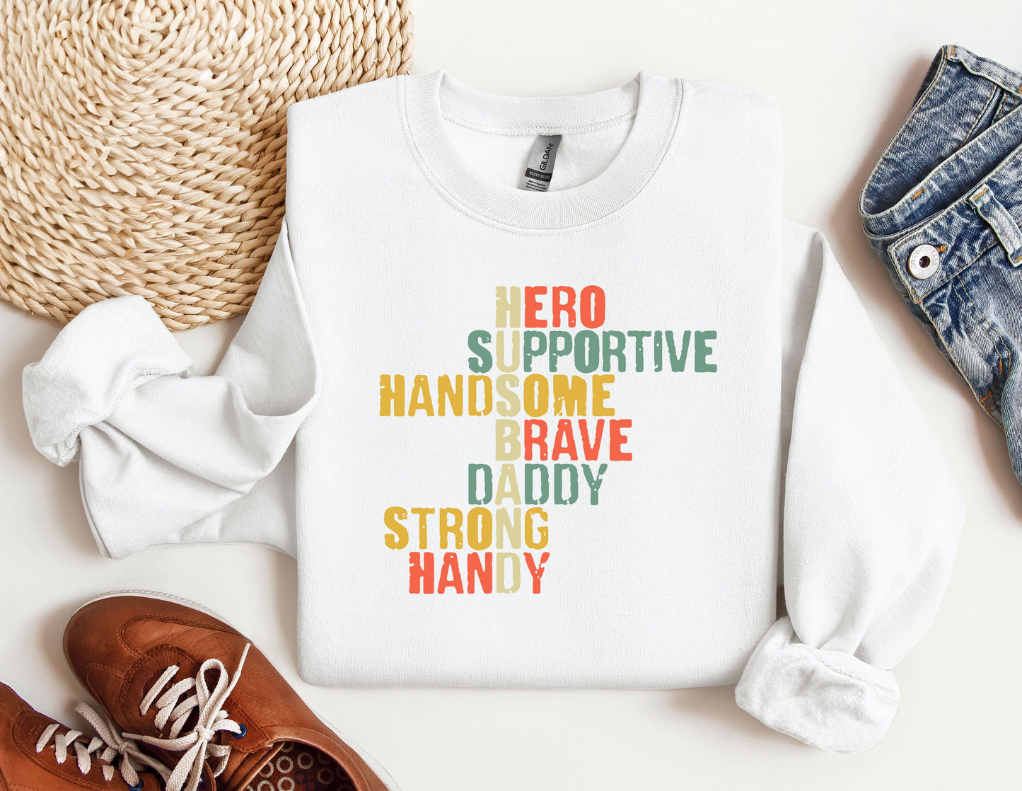 a white sweatshirt with the words hero is positive and a pair of brown shoes