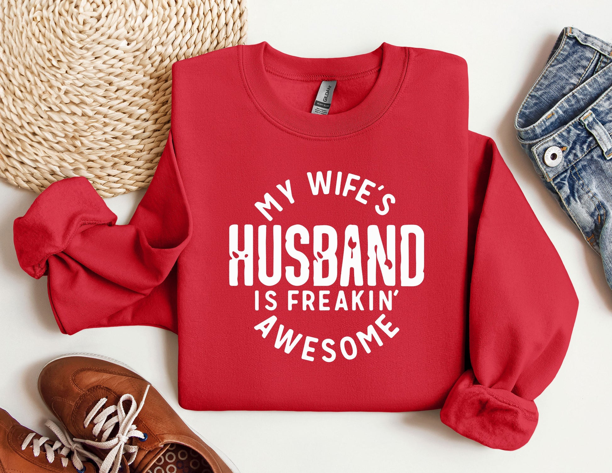 a red sweatshirt that says, my wife&#39;s husband is freakin&#39;awesome