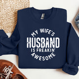 a sweatshirt that says, my wife's husband is freakin'awesome