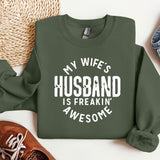 a sweatshirt that says, my wife's husband is freakin'awesome