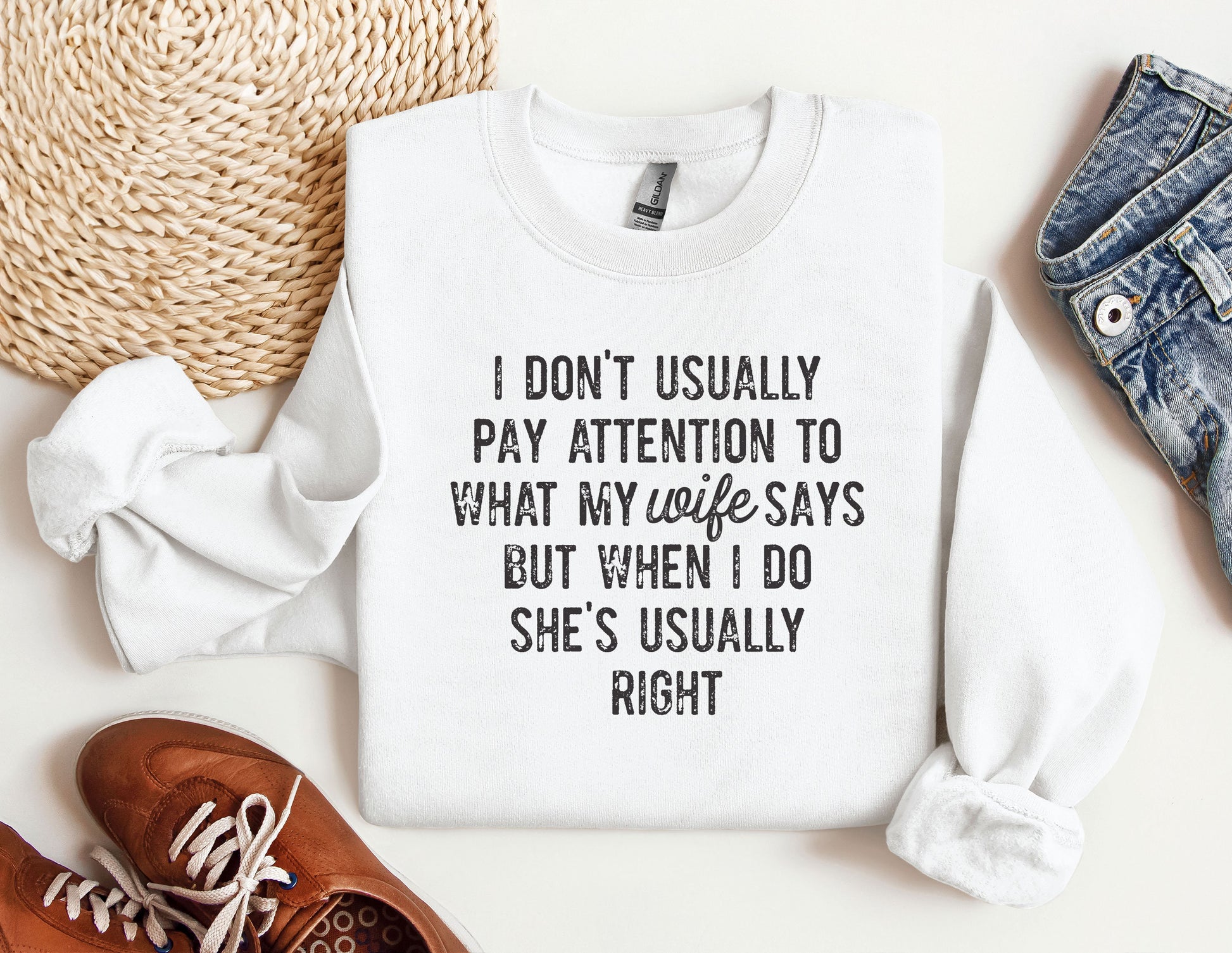 a sweater with a quote on it next to a pair of shoes