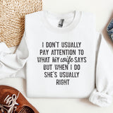 a sweater with a quote on it next to a pair of shoes