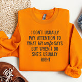 an orange sweatshirt with a quote on it next to a pair of shoes