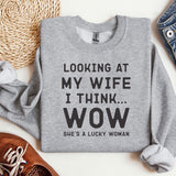 a sweater that says looking at my wife i think wow she's a lucky