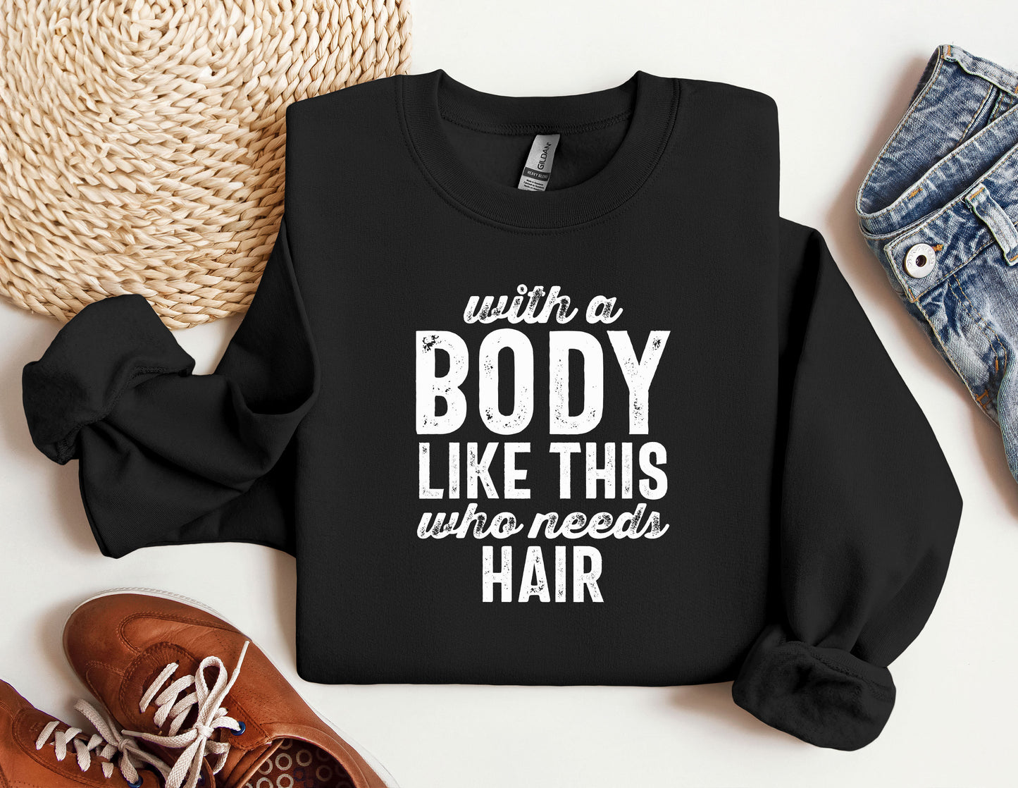a black sweatshirt with white writing on it next to a pair of shoes