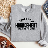 a sweater that says under new management speak to my wife