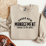 a sweater that says under new management i speak to my wife