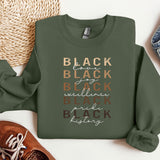 a green sweatshirt with the words black and white on it