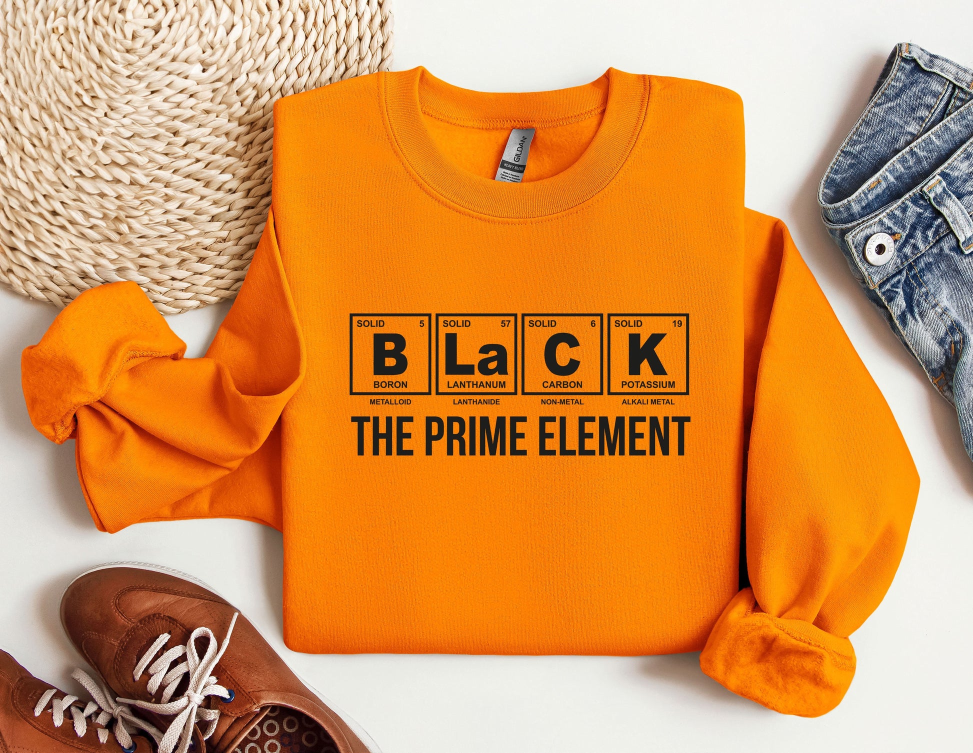 an orange shirt that says black the prime element