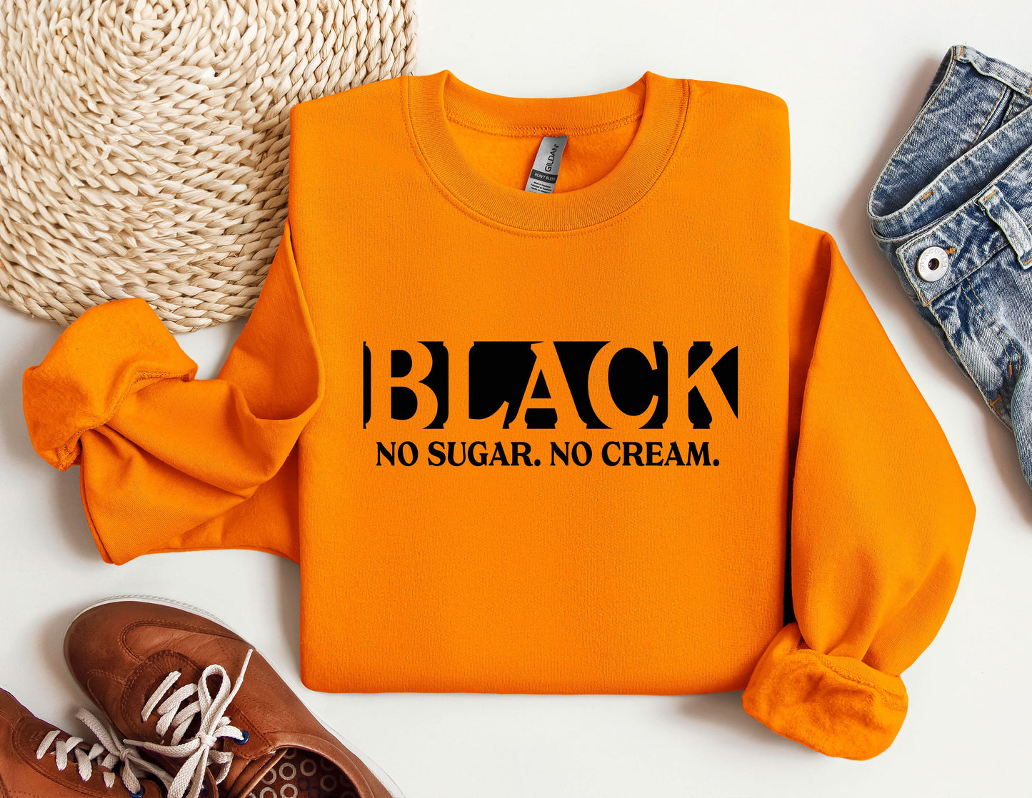 a pair of shoes and an orange sweatshirt with the words black, no sugar,