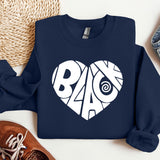 a blue sweatshirt with a white heart on it