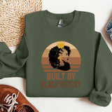 a green sweatshirt with a picture of a woman's face and the words built