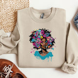 a sweater with a picture of a woman with flowers on it