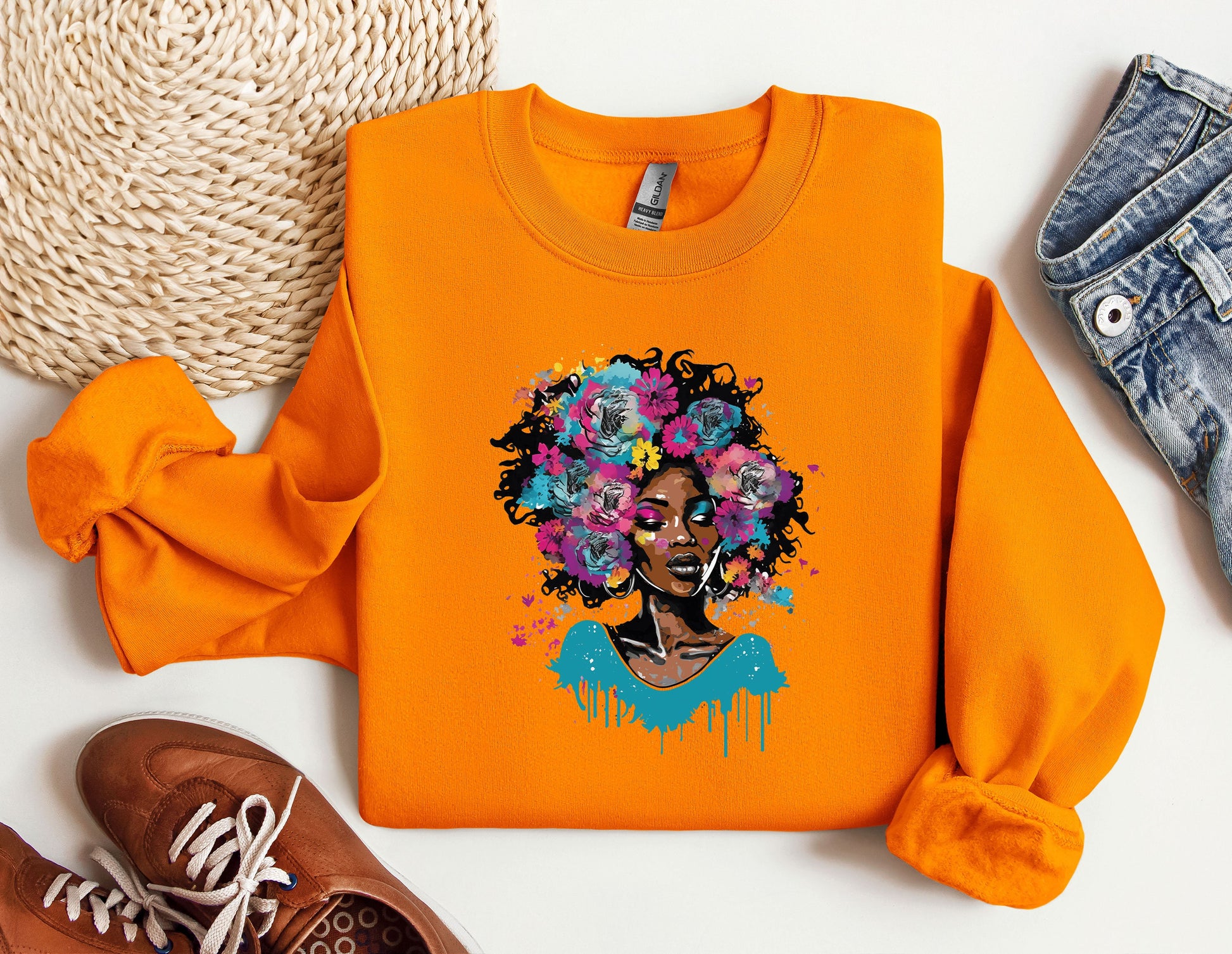 an orange shirt with a picture of a woman with flowers on it