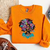 an orange shirt with a picture of a woman with flowers on it