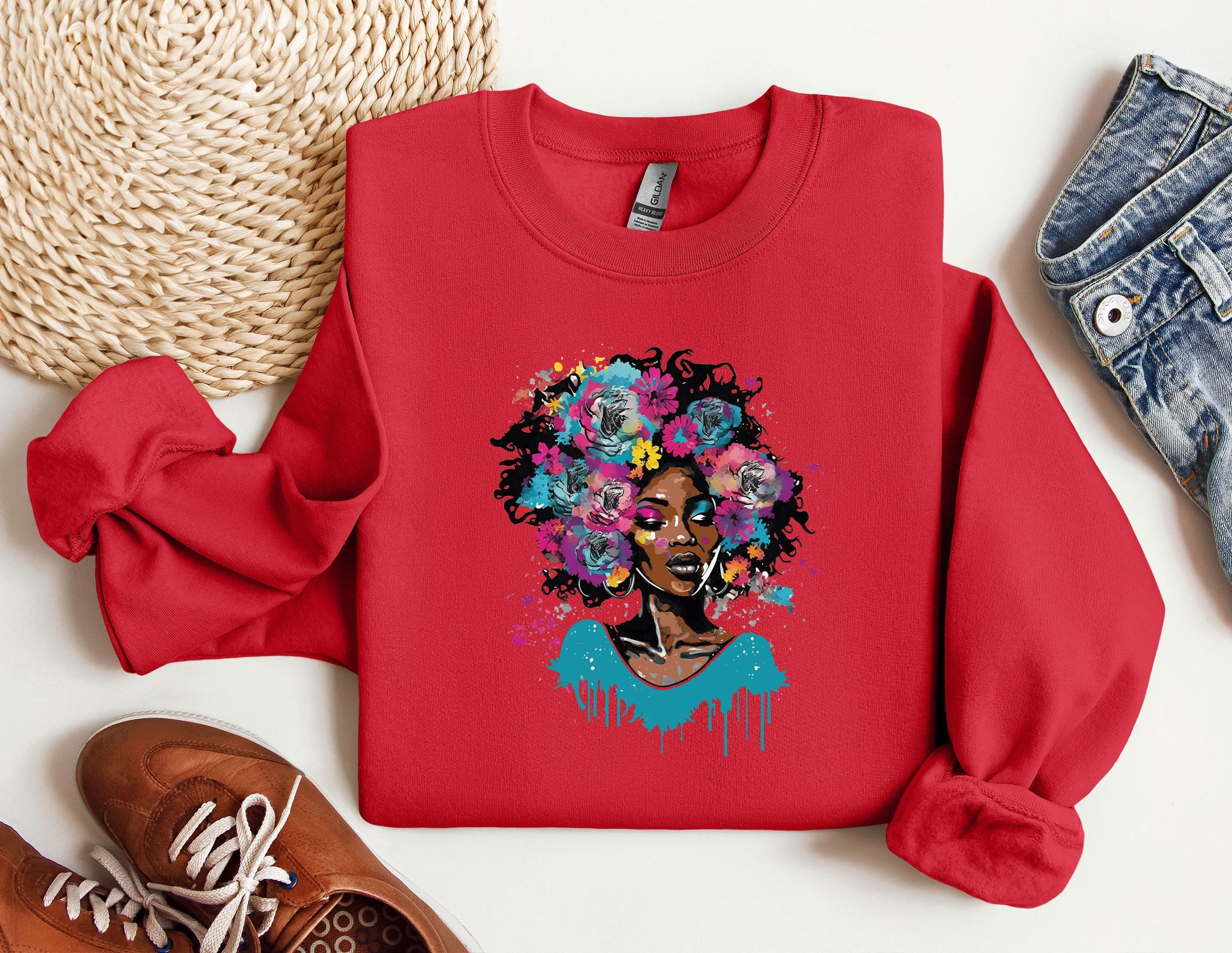 a red sweatshirt with a picture of a woman with flowers on it