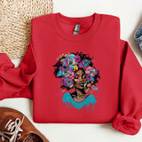 a red sweatshirt with a picture of a woman with flowers on it