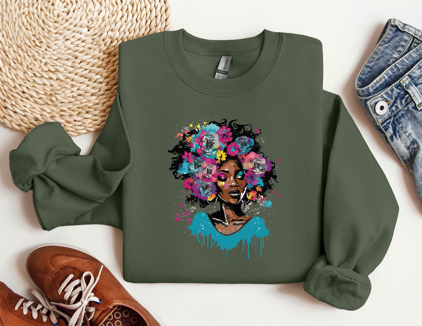 a green sweatshirt with a picture of a woman with flowers on it